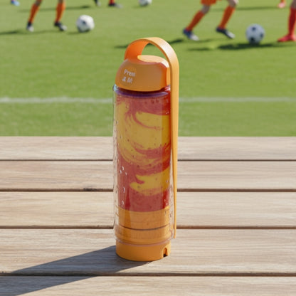 Orange koor refillable bottle with a yellow sleeve on a wooden surface, with a soccer field in the background.