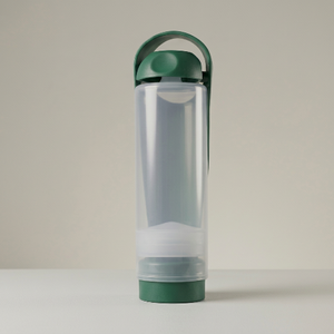 refillable koor bottle with green cap and base on a light gray background